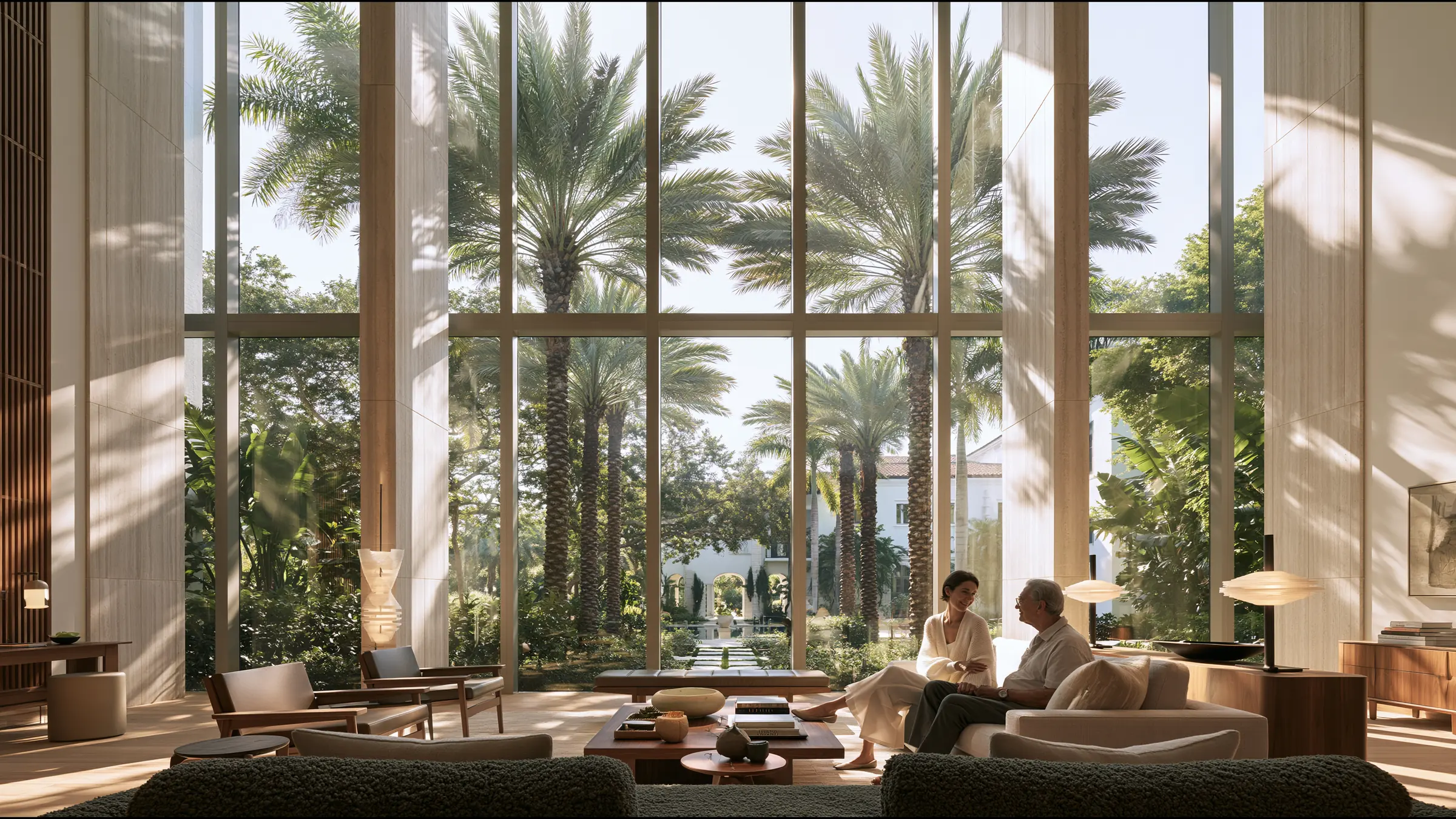 A family physician in her forties in fine knit laughing gently with an older patient in a vast sunlit consulting suite in Coral Gables, Miami, palms and a Mediterranean villa garden through tall glass
