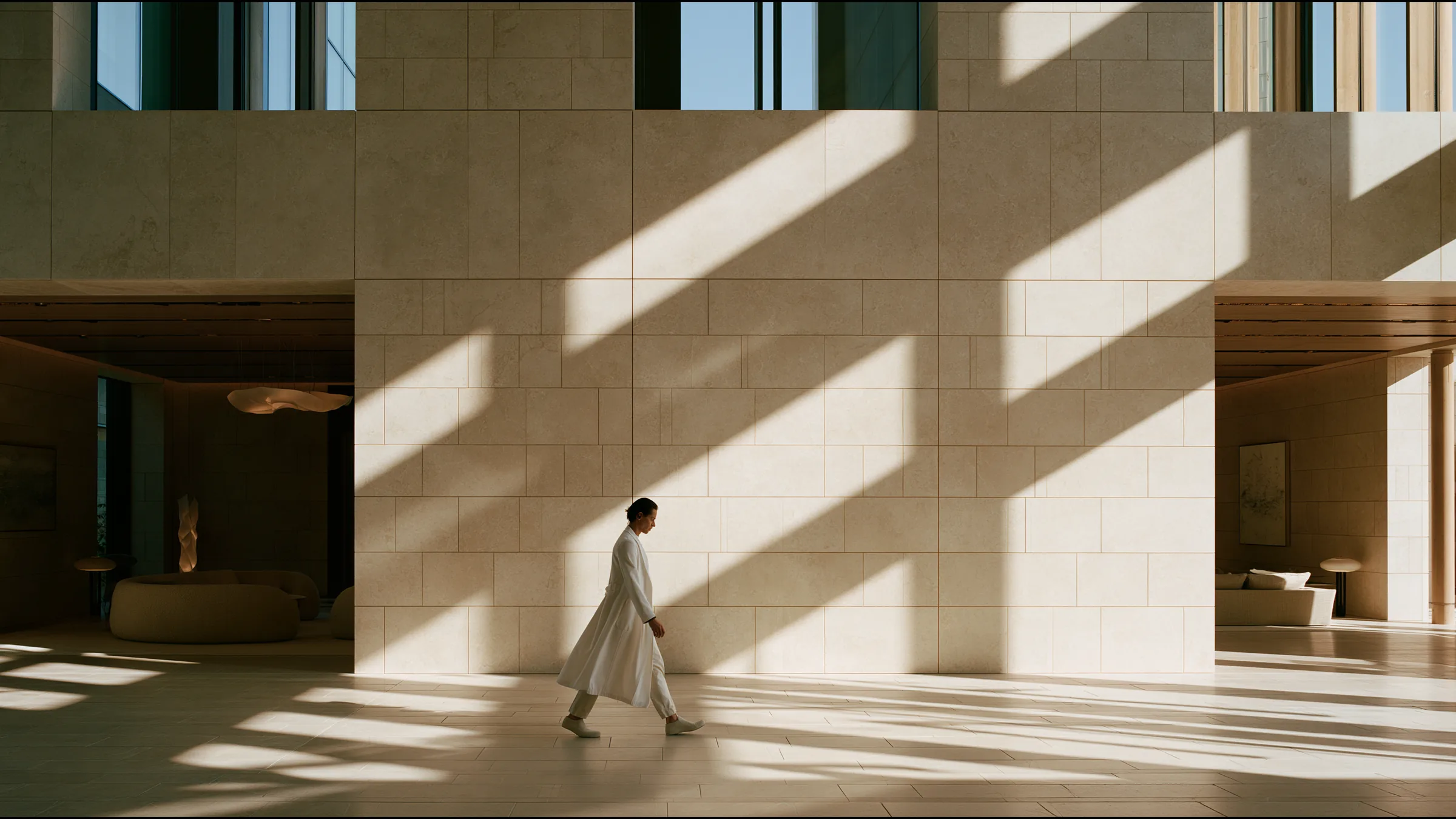 A clinician at ease in a vast, light-filled private clinic in Bristol, the city beyond the glass
