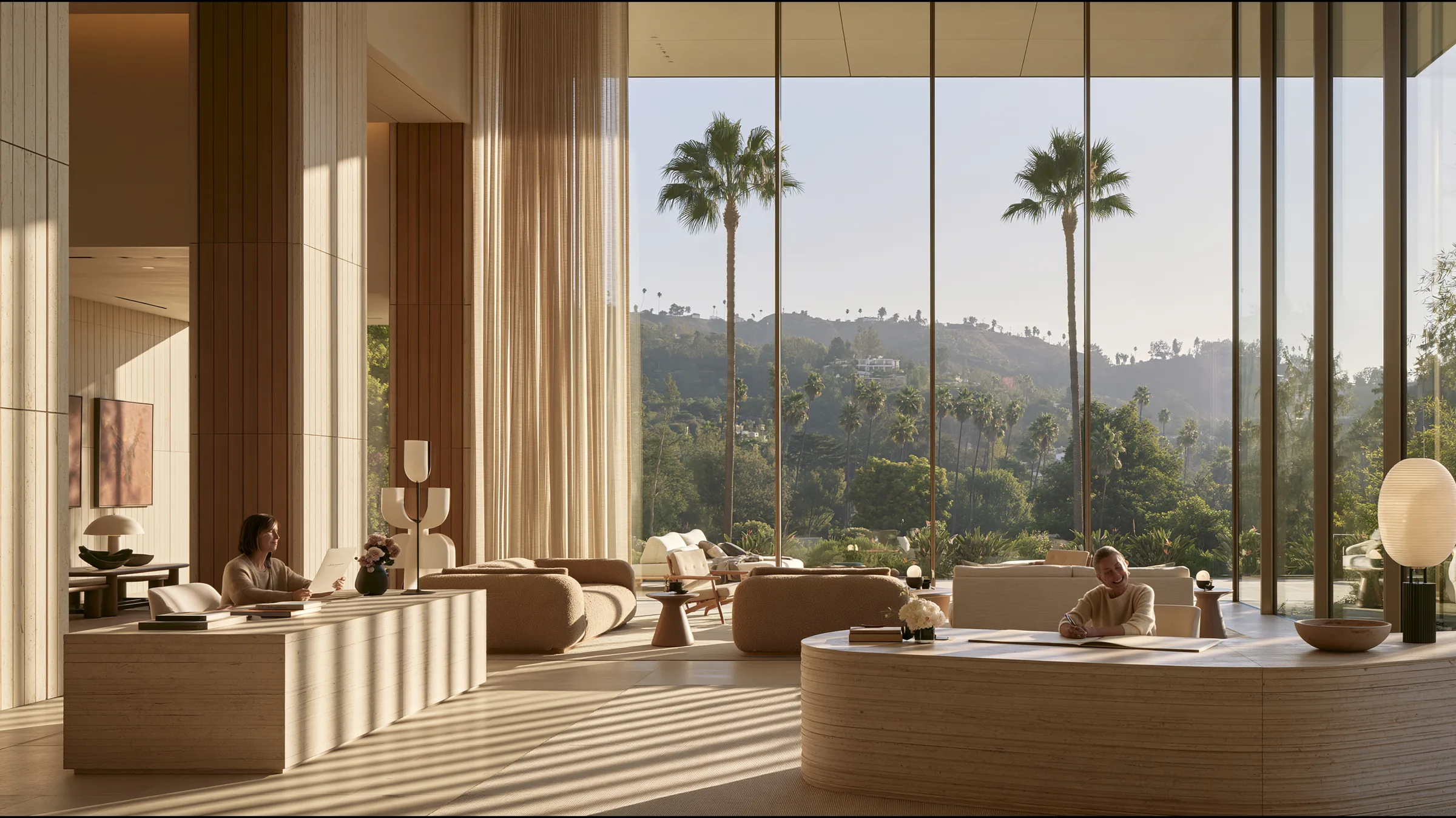 An operations lead in her fifties in fine knit alone at a corner travertine desk in a vast bright Beverly Hills clinic, a single page, a relaxed smile at a month closed, palms and the hills beyond the glass
