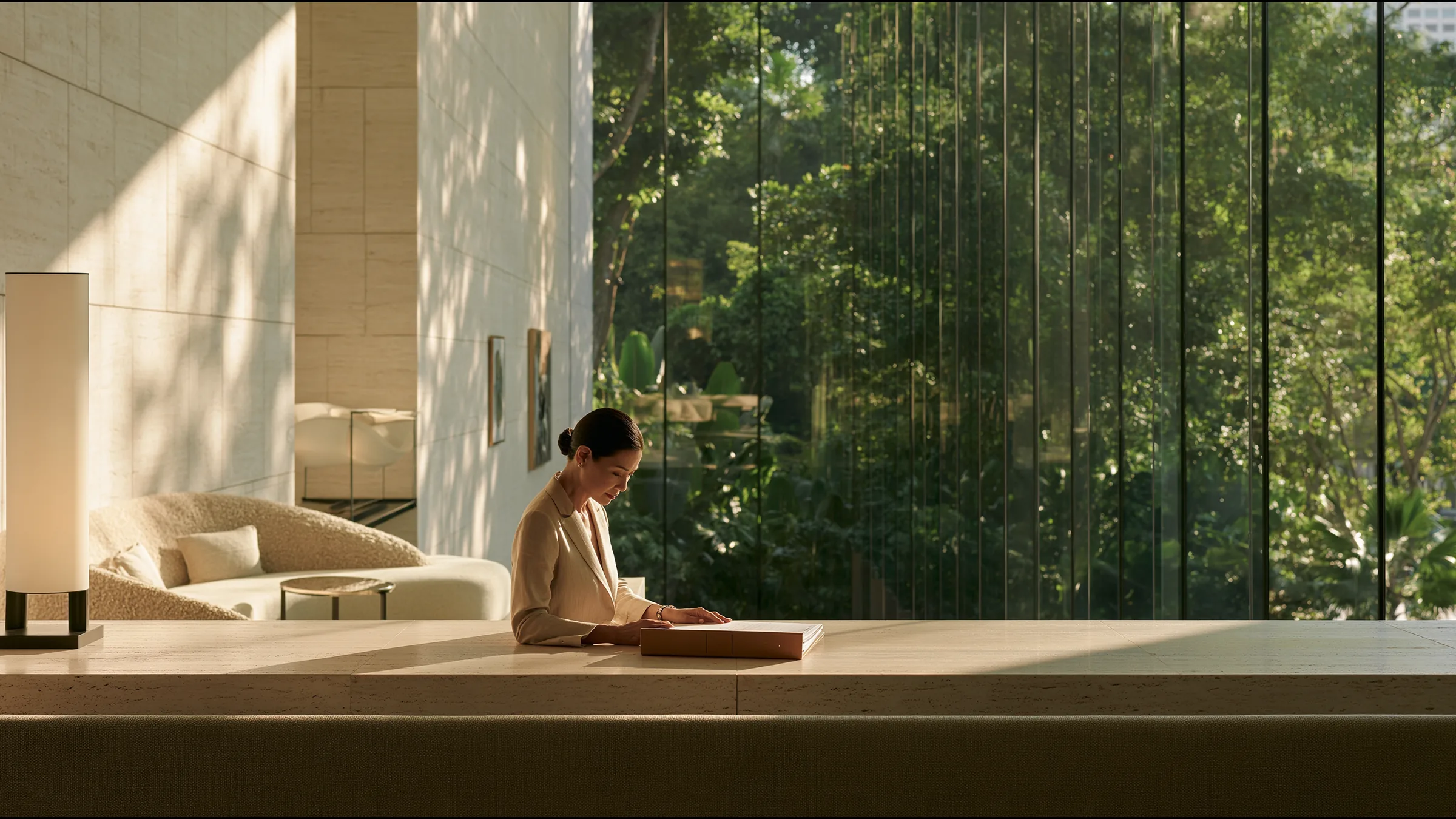 A medical director in her fifties alone at a long pale stone table in a vast bright clinic above Orchard Road, Singapore, reviewing a single bound document with assurance, tropical green beyond