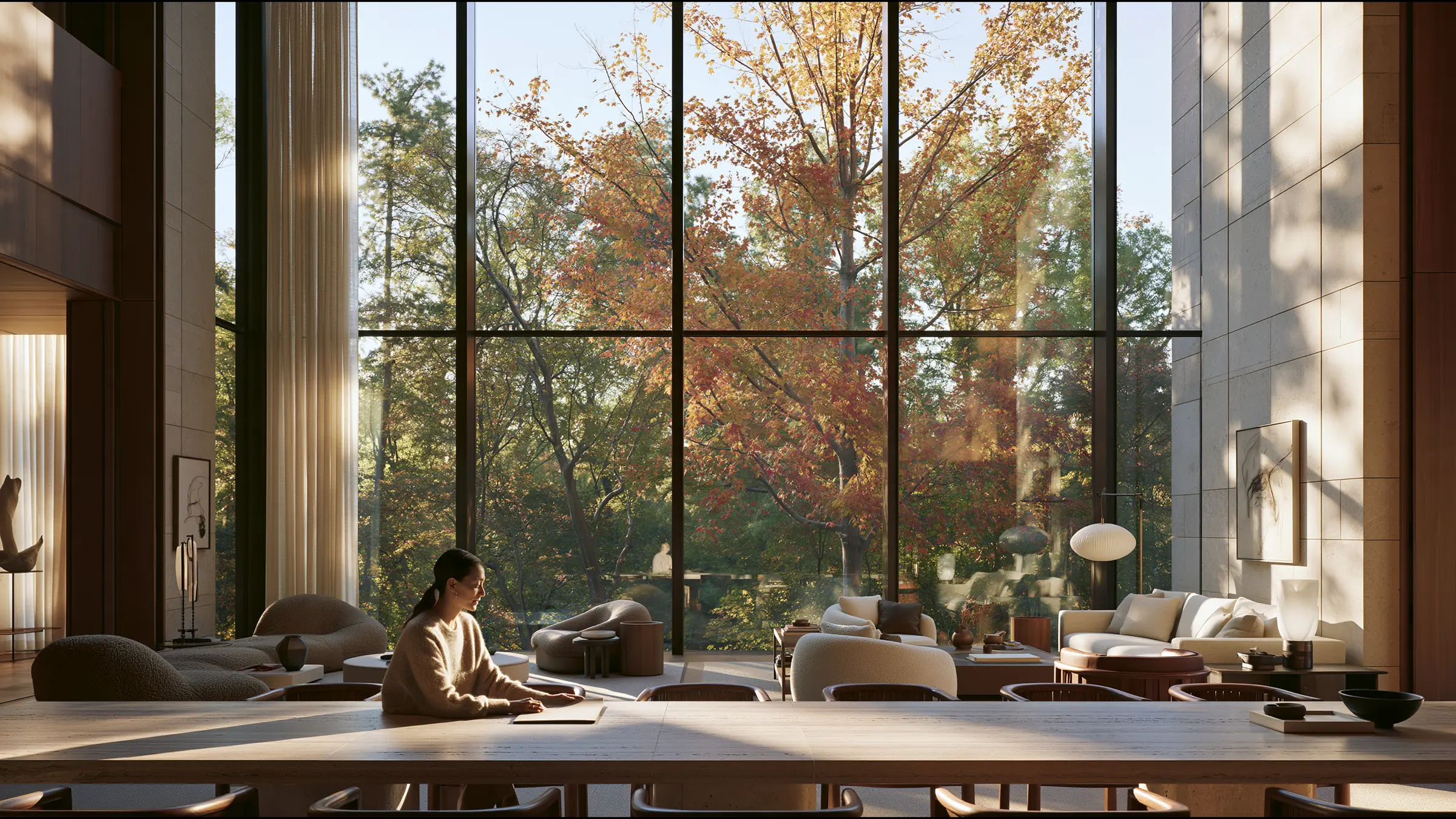 A woman in her late thirties at a long travertine table in a vast sunlit Yorkville apartment in Toronto, one slim folder before her, calm and organised, autumn treetops through floor-to-ceiling glass